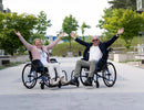 Elderly Man And Woman Sitting In The Strongback 24 Ultra-Lightweight Wheelchair Shown In An Outdoor Setting