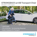 Elderly Woman Folding The Strongback 12 +AB Lightweight Transport Chair In An Outdoor Setting Demonstrating Its Lightweight Frame