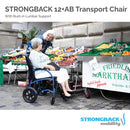 Elderly Woman Sitting In The Strongback 12 +AB Lightweight Transport Chair With Friend Standing Beside Her Shown In An Outdoor Grocery Store Environment