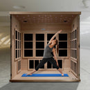 Front Centered Interior View Of The Golden Designs Catalonia 8-Person Near Zero EMF ADA Indoor Sauna | GDI-6880-02 Shown With A Fit Woman Striking A Yoga Pose