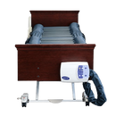 Front Centered View Of A Hospital Bed Shown With The Joerns DermaFloat APL Alternating Pressure Low Air Loss Therapy Mattress System On The Frame With Control Unit Hanging Off The Footboard Panel