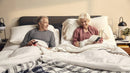 Front Centered View Of Elderly Couple Sitting Up On An Adjustable Bed With The Luxury Dawn House Foam Mattress