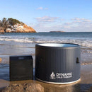 Front Centered View Of The Dynamic Round Inflatable Cold Plunge With Chiller Shown In A Beach Setting