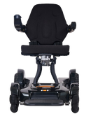Front Centered View Of The Golden Technologies Ally Sport Omnidirectional Electric Wheelchair Shown In Carbon Fiber Color