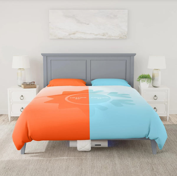 Front Centered View Of The Rize Home Smart Duvet With Blue Light Color On Gray Bedframe Shown In Bedroom Setting With White Walls And Nightstands And Orange And Blue Color  Shown On Each Side Of The Duvet