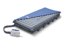 Front Centered View Of The Wellell Domus 3 Alternating Pressure Redistribution Mattress System With Quilted Cover Shown With Control Unit And Cover Slightly Removed