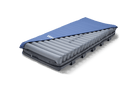 Front Centered View Of The Wellell Domus 3 Alternating Pressure Redistribution Mattress System With Quilted Cover Shown With Cover Slightly Removed