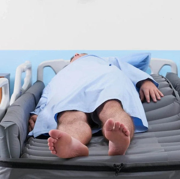 Front Centered View Of The Wellell Optima Turn Lateral Rotation Pressure Relief Mattress With Stretch Cover With Patient Lying On The Mattress In The Lateral Rotation Position