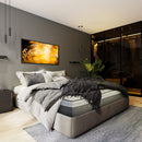 Front Left Side View Of The Eurolux Lux Silver: The 5-Layer Luxury Mattress Crafted By Masters Shown On A Platform Bed Frame In A Bedroom Setting With Blankets And Pillows On The Mattress
