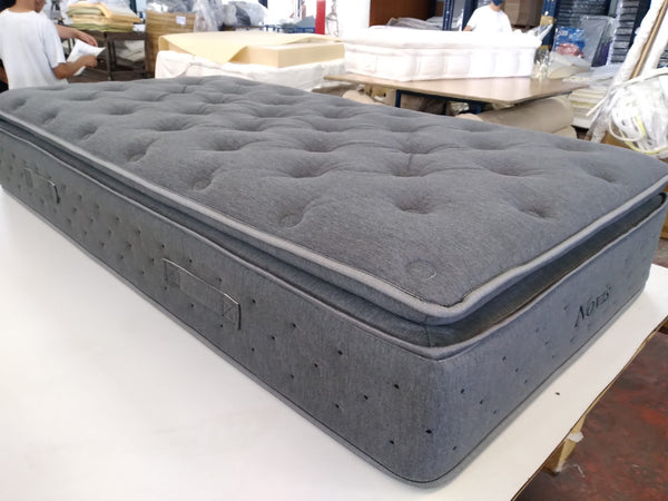 Front Left Side View Of The Eurolux Novis: The 5-Layer Luxury Mattress Crafted By Masters Shown In A Factory Setting