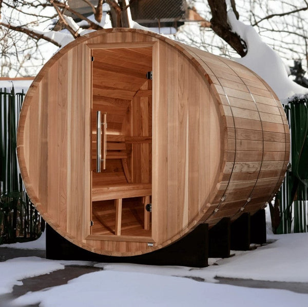 Front Left Side View Of The Golden Designs Klosters 6-Person Barrel Sauna | GDI-B006-01 Shown In A Snowy Outdoor Setting