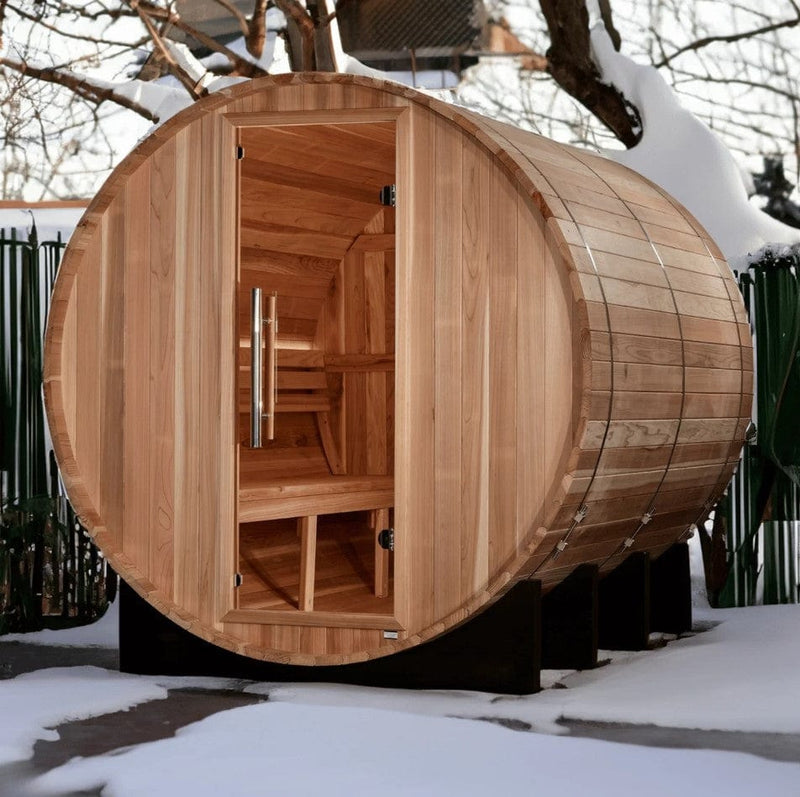 Front Left Side View Of The Golden Designs Klosters 6-Person Barrel Sauna | GDI-B006-01 Shown In A Snowy Outdoor Setting