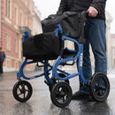 Front Left Side View Of The Strongback Mobility SEATA Rollator Shown With Elderly Man Holding The Handles In An Outdoor Setting