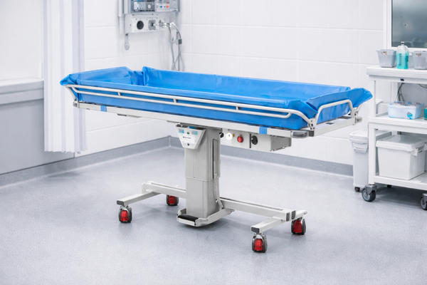 Front Left Side View Of The TR Equipment Battery Operated Shower Trolley TR-3000 Shown In A Medical Setting