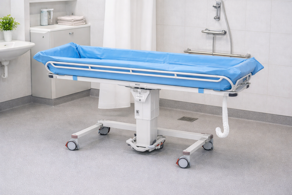Front Left Side View Of The TR Equipment Hydraulic Shower Trolley TR-2000 Shown In A Medical Setting