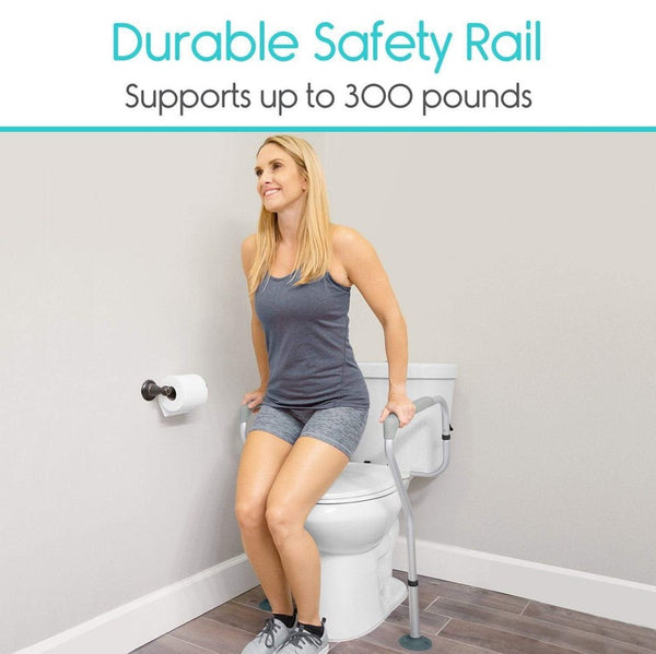 Front Left Side View Of The Vive Health Toilet Safety Rail Shown With A Woman Using The Railing To Stand Up Demonstrating Its Durable 300 Pound Weight Capacity