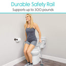 Front Left Side View Of The Vive Health Toilet Safety Rail Shown With A Woman Using The Railing To Stand Up Demonstrating Its Durable 300 Pound Weight Capacity