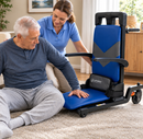 Front Right Side View Of A Man Being Assisted By A Caregiver Onto The Lift Buddy Floor Recovery Lift