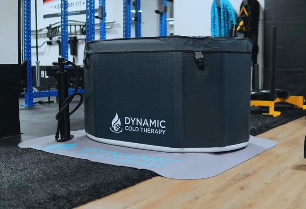 Front Right Side View Of The Dynamic Oval Inflatable Cold Plunge Shown With Cover In A Gym Setting
