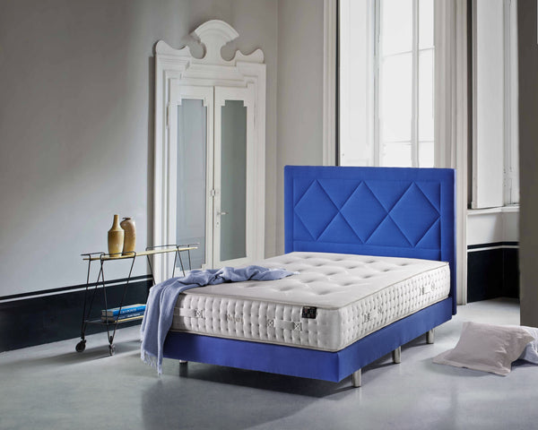 Front Right Side View Of The Eurolux Natur: The 6-Layer Luxury Mattress Crafted By Masters Shown On A Blue Bed Frame In A Luxury Bedroom Setting