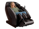 Front Right Side View Of The Kyota Hatsumei M900 AI 4D Massage Chair In Dark Brown Color Shown With Woman Sitting In The Chair