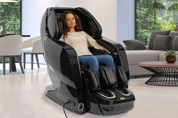 Front Right Side View Of The Kyota Yosei M868 Massage Chair In Black Color Shown In An Indoor Setting With A Woman Sitting In The Chair