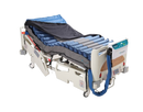 Front Right Side View Of The Proactive Medical Protekt Aire 8900 Low Air Loss/Alternating Pressure And Pulsation Mattress System With "On Demand Side Air Bolsters" Shown With Cover Slighly Removed While Lying On An Adjustable Hospital Bed With Control Unit Hanging On The Footboard