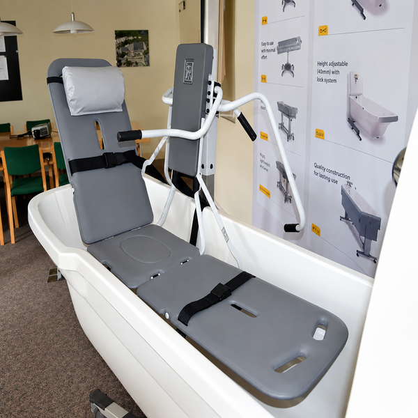 Front Right Side View Of The TR Equipment Mobile Stretcher Lift TR9650 Shown Inside A Tub In A Showroom Setting