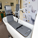 Front Right Side View Of The TR Equipment Mobile Stretcher Lift TR9650 Shown Inside A Tub In A Showroom Setting