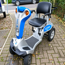 Front Right Side View Of The Tzora Titan 4 Hummer Medical Mobility Scooter Shown In An Outdoor Setting On A Brick Path