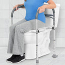 Front Right Side View Of The Vive Health Toilet Safety Frame With Handles Shown With A Woman Using The Rails For Support While Sitting On The Toilet