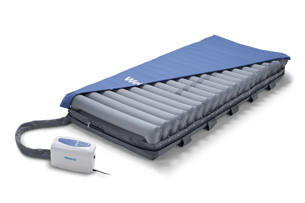 Front Right Side View Of The Wellell Domus Auto Pressure Redistribution Mattress System With Quilted Cover Shown With Cover Slightly Removed