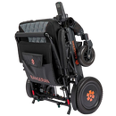 Front Right View Of The Bangeran Mammoth EX Automatic Folding Electric Wheelchair Shown In Black And Orange Color In The Folded Position