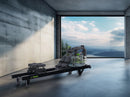 Front View Of The Dynamic Fluid Fitness S660 Rower In A Home Setting With Mountains In The Background