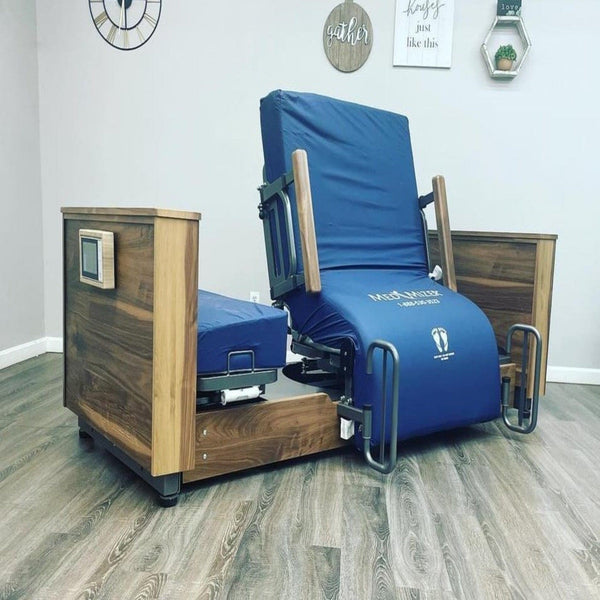 Front View Of The Med Mizer Active Care Deluxe Rotating Bed With Leg Rails And Bed In The Chair Position In A Home Setting