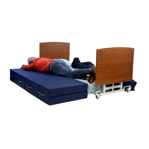 Front View Of The Med Mizer AllCare AC-N Ultra Low Adjustable Bed In The Flat Position Shown With Man Transitioning From Mattress To Safety Mat And Cherry Boards