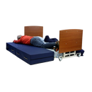 Front View Of The Med Mizer AllCare AC-N Ultra Low Adjustable Bed In The Flat Position Shown With Man Transitioning From Mattress To Safety Mat And Cherry Boards