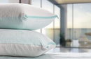 Front View Of Two Eurolux Green Planet Pillows Stacked On Each Other Lying On A Surface Shown In An Indoor Home Setting
