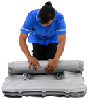 Healthcare Worker Rolling The Winncare Mangar Camel 