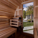 Inside View Of The Golden Designs Zurich 4-Person Barrel Sauna | GDI-B024-01 Showing The Front Door And The Heater With A Palm Tree In The Background