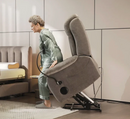 Left Side View An Elderly Woman Rising Out Of The StarSleep Starise Massage Lift Chair Shown In A Bedroom Setting