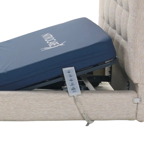 Left Side View Of The Mattress And Remote Control Of The Nitrocare Miranda Hi Low Adjustable Bed Shown With The Head Portion Of The Frame Slightly Raised