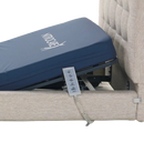 Left Side View Of The Mattress And Remote Control Of The Nitrocare Miranda Hi Low Adjustable Bed Shown With The Head Portion Of The Frame Slightly Raised