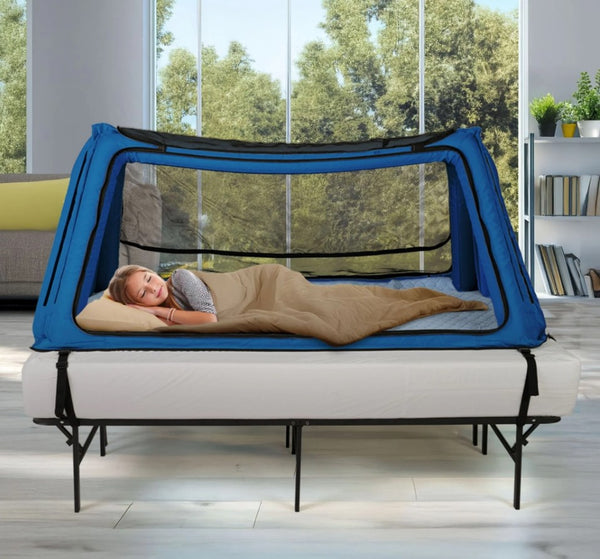 Left Side View Of The Safe Place Bedding Model 100 Safe Place Travel Bed Shown In Blue Color With Young Girl Sleeping Inside In A Home Setting
