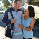 Man And Woman Standing Together Outdoors, Smiling Shown With Man Using The O2 Concepts Oxlife Liberty2 Portable Oxygen Concentrator