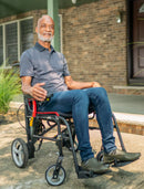 Man Sitting In The Feather Electric Wheelchair Outdoors On A Patio