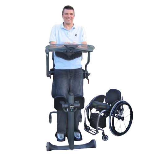 Man Using The EasyStand Evolv XT Shown With Wheelchair At His Side