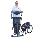 Man Using The EasyStand Evolv XT Shown With Wheelchair At His Side