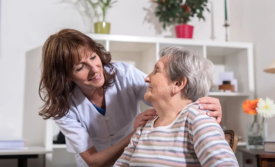 Caregiver helping an older woman at home