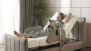Orin Rotating Bed In Side View With Elderly Woman Looking At Her Phone In Elevated Head Position